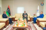 A meeting between the National Oil Corporation and Schlumberger to discuss development and training programs.