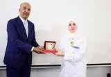 (Al-Koni) awards the Good Work Medal to the Director of the Eye Hospital, Dr. (Rania Al-Khoja)